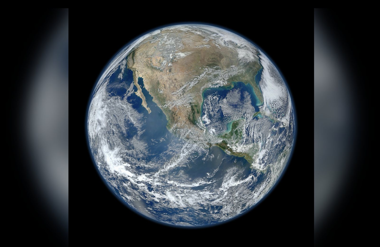 Fullscreen playback of NASA's Blue Marble photograph of Earth, fitted with softly blurred bars on either side