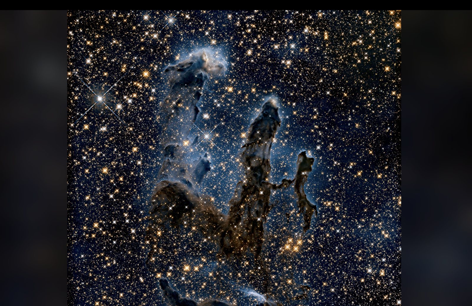 Fullscreen playback of the Pillars of Creation nebula, fitted with softly blurred bars on either side